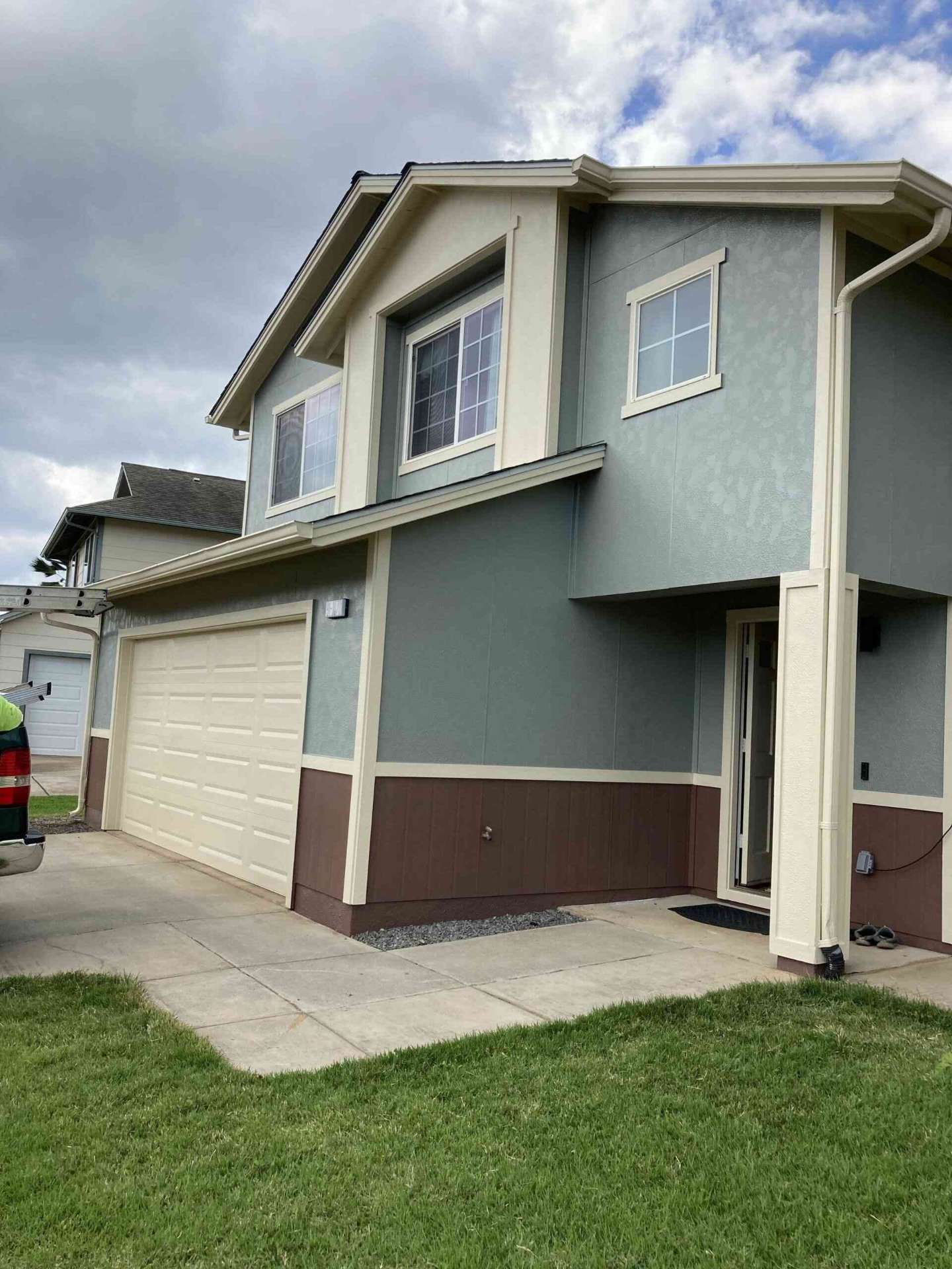 Two-tone exterior repaint on a Makakilo hillside home